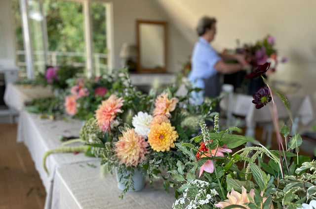 Pod & Pip's autumn and winter flower workshops, with a beautiful display of flowers laid out on a table