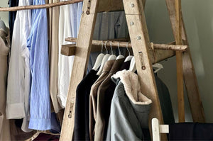 A range of Pod & Pip's specially selected clothing line, displayed on wooden ladders for a rustic feel, sold at the Pod & Pip Workshop